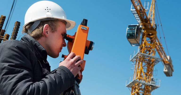 A young person using a theodolite